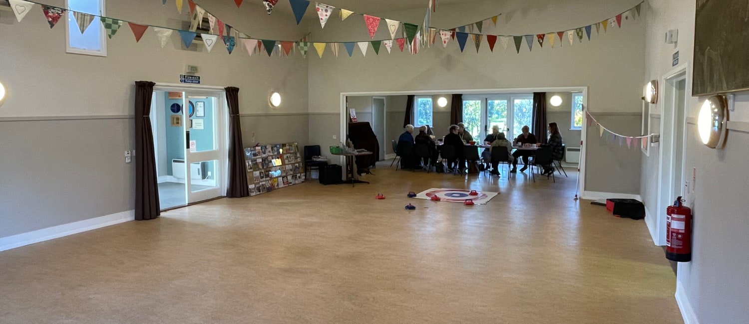 Interior of Brookland Village Hall showing the small hall opened up hosting and meeting 